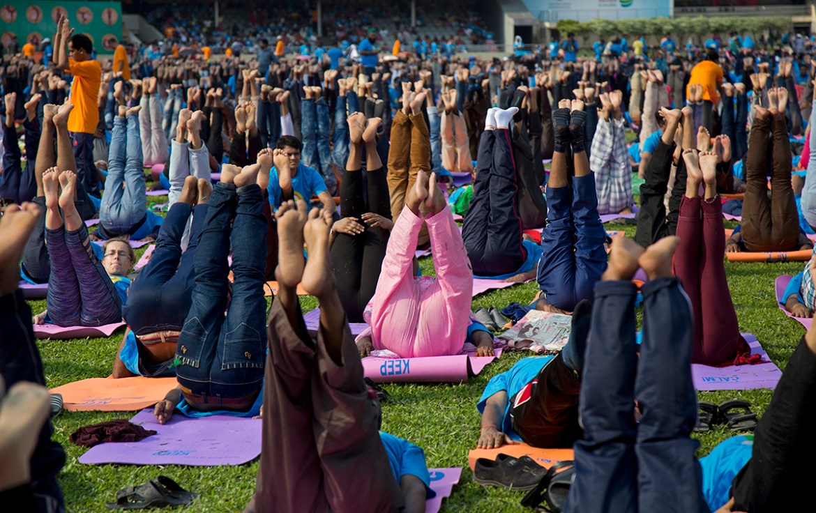 People performs yoga during the 4th International Day of Yoga at Bangabandhu National Stadium in Dhaka, Bangladesh, 21 June 2018. More than 5,000 people participated in the event organized by the Indi