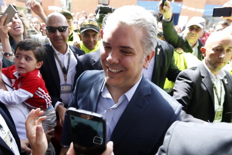Presidential candidate Duque with supporters after casting his vote during the second round of the presidential election in Bogota