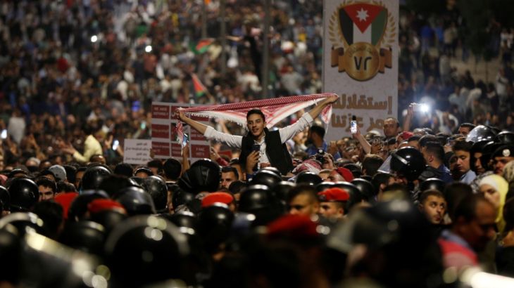 Protesters shout slogans during a protest in Amman