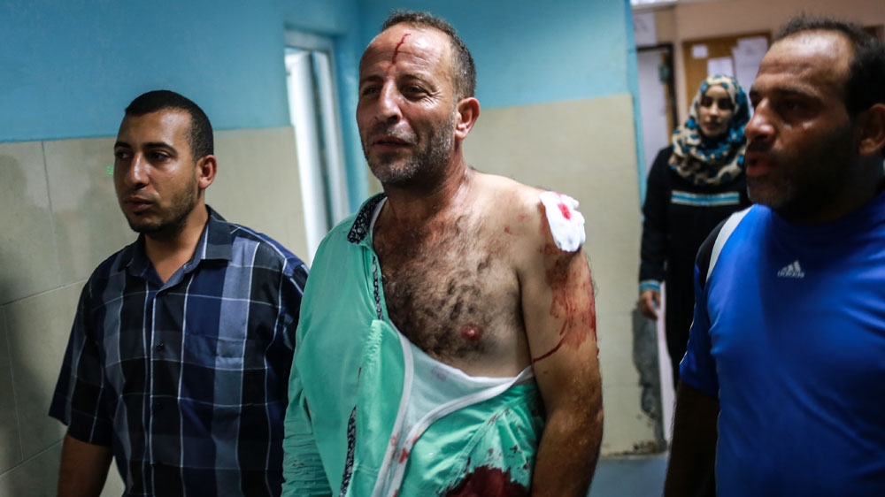 A wounded Palestinian man inside al-Shifa hospital in Gaza [Hosam Salem/Al Jazeera]