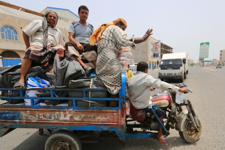 People displaced by the fighting near the Red Sea port city of Hodeidah transport blankets and other aid kits they received from United Nations agencies in Hodeidah, Yemen