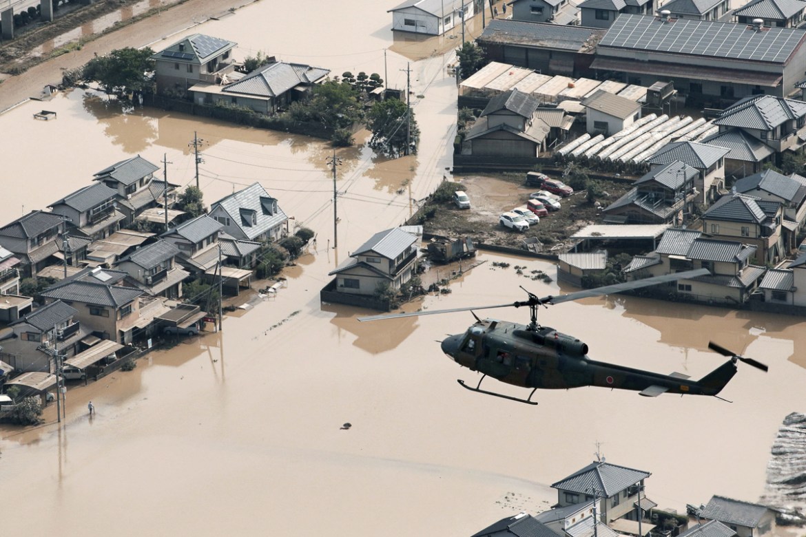 A helicopter flies over Mabi town which was flooded by the heavy rain in Kurashiki, Okayama Prefecture, Japan, in this photo taken by Kyodo July 9, 2018. Mandatory credit Kyodo/via REUTERS