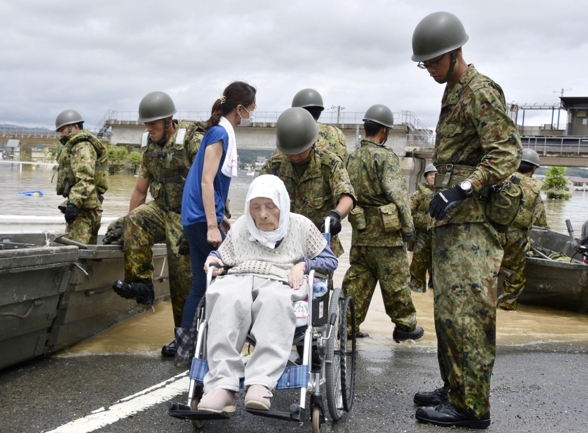 An elderly man in a wheelchair is rescued from a flooded area in Kurashiki, Okayama Prefecture, Japan, in this photo taken by Kyodo July 8, 2018. Mandatory credit Kyodo/via REUTERS