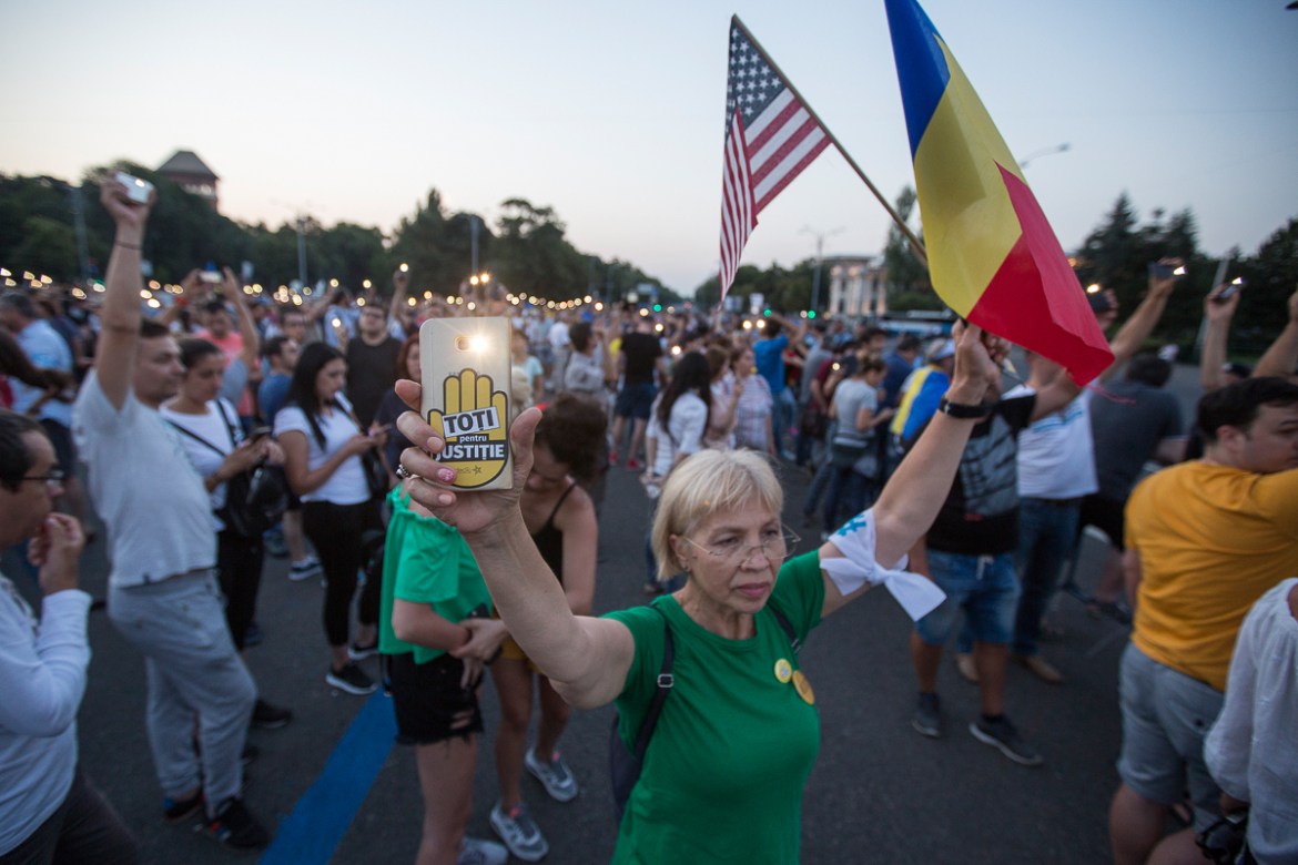 14. A protester holds up a smartphone lantern with the message “Everybody for justice” during an anti corruption protest in Bucharest.