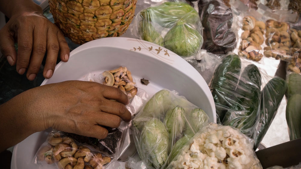 To make a small living, Martinez sells vegetables, nuts and fruits [Kimberly dela Cruz/Al Jazeera]
