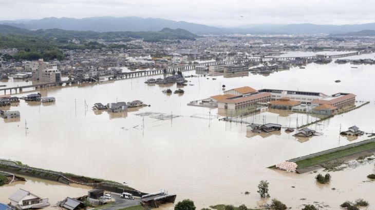 A broken river bank is seen after heavy rain in Kurashiki