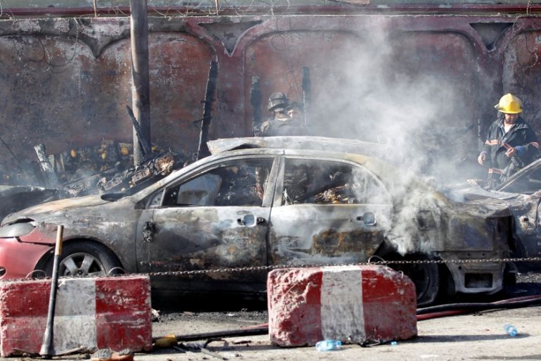Afghan officials inspect the site of a blast in Jalalabad city