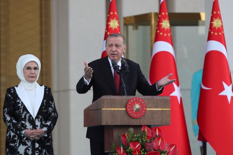 Turkish President Tayyip Erdogan, accompanied by his wife Emine Erdogan, makes a speech during a ceremony at the Presidential Palace in Ankara