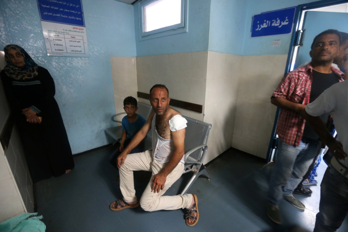 Wounded Palestinian sits at the hospital following Israeli air strikes in Gaza City July 14, 2018. REUTERS/Ibraheem Abu Mustafa