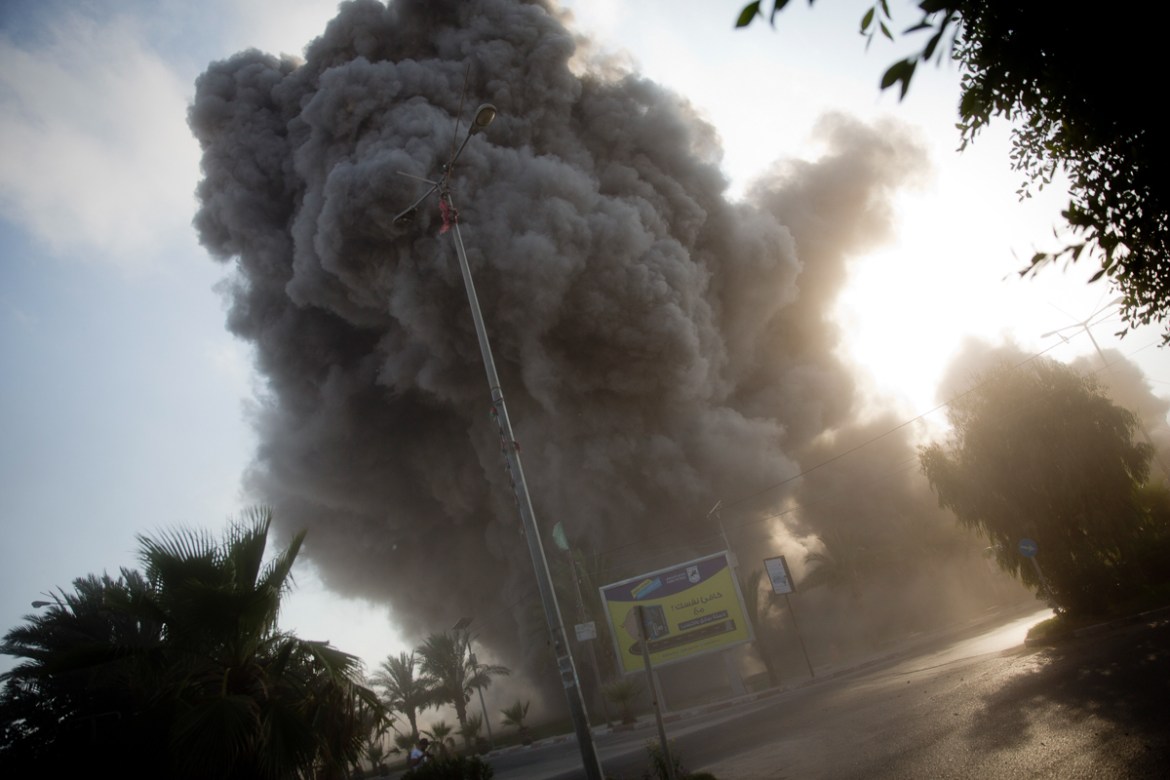 Smoke raises in the background following an Israeli airstrike hits a governmental building in Gaza City , Saturday, July 14, 2018. The Israeli military carried out its largest daytime airstrike campai