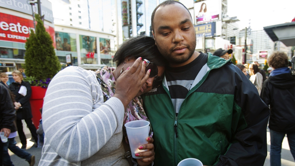Survivors of the 2012 shooting at the Toronto Eaton Centre hold a vigil [Mark Blinch/Reuters] 