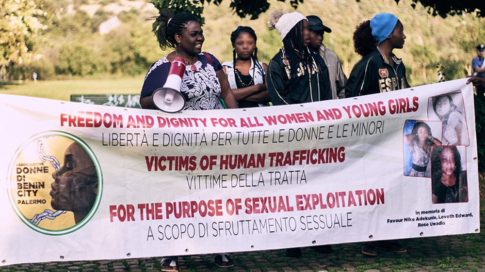 Women of Benin remembers a late trafficking victim, Favour Nike Adekule, in the spot where she was murdered by her client [Naomi Morello/Al Jazeera]