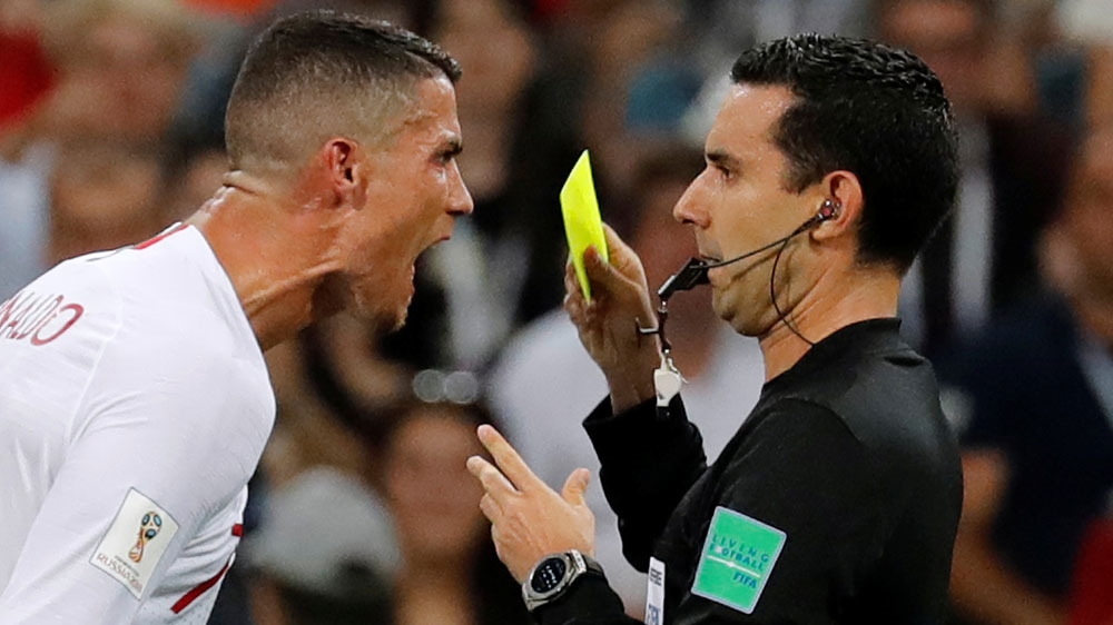 Referee Cesar Arturo Ramos handed Ronaldo the only card of the match [Toru Hanai/Reuters]