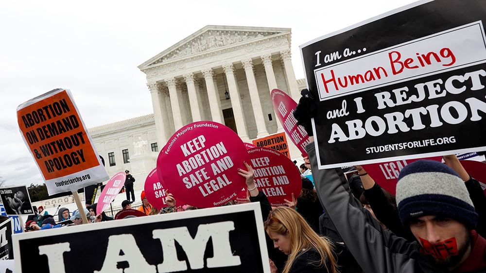 Pro-abortion and anti-abortion rights activists gather at the Supreme Court for the National March for Life rally in Washington, DC [Aaron P Bernstein/Reuters]
