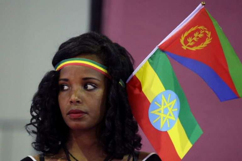 Woman wears the Ethiopian and Eritrean national flags during a concert in Addis Ababa