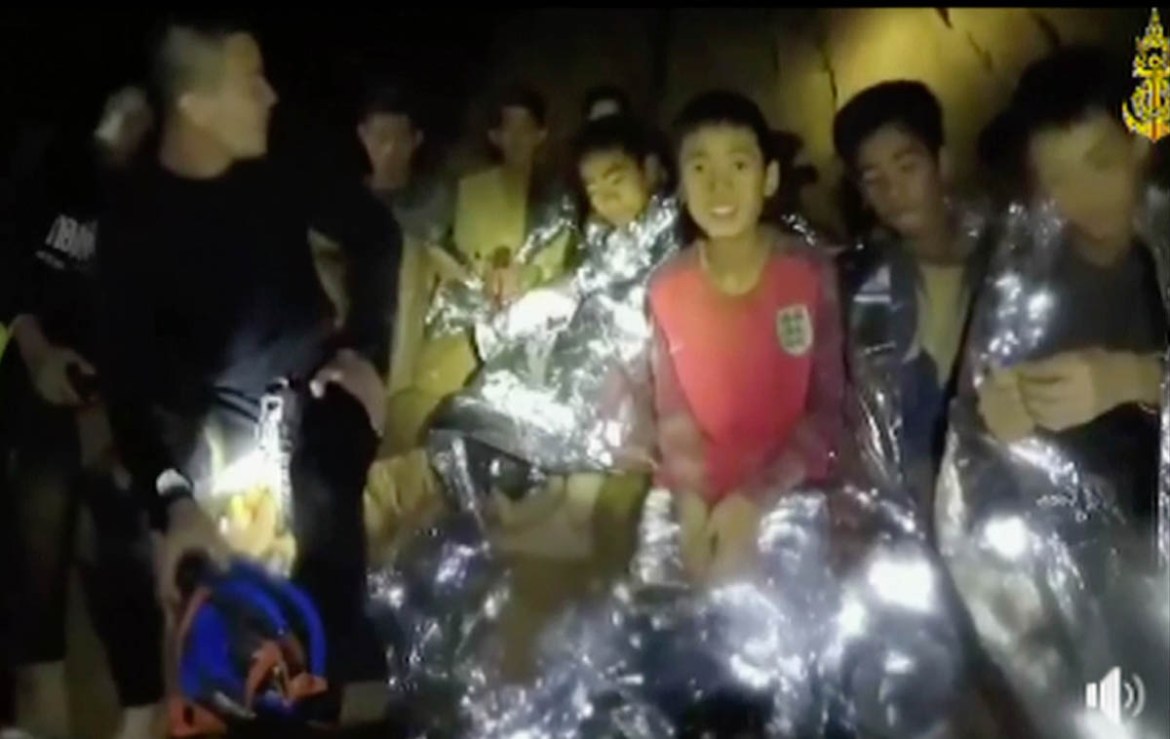 In this July 3, 2018, image taken from video provided by the Thai Navy Seal, Thai boys are with Navy SEALs inside the cave, Mae Sai, northern Thailand. With heavy rains forecast to worsen flooding in