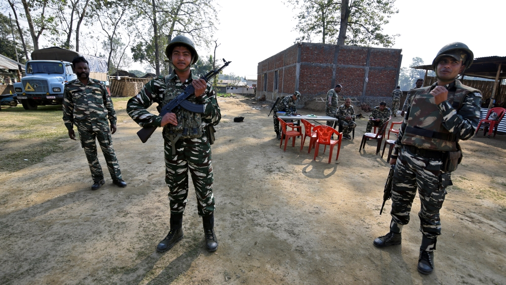 Central Reserve Police Force (CRPF) personnel stand guard at a temporary camp ahead of the publication of the first draft of the National Register of Citizens (NRC) [File: Anuwar Hazarika/Reuters]