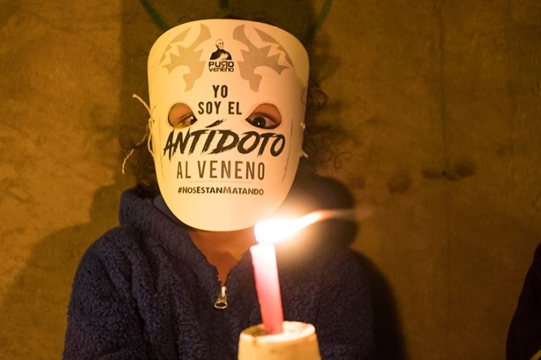 A child holds a candle in protest of the activists killed since the signing of peace agreements in Colombia, Bogota on July 6, 2018. (Photo by Daniel Garzon Herazo/NurPhoto)