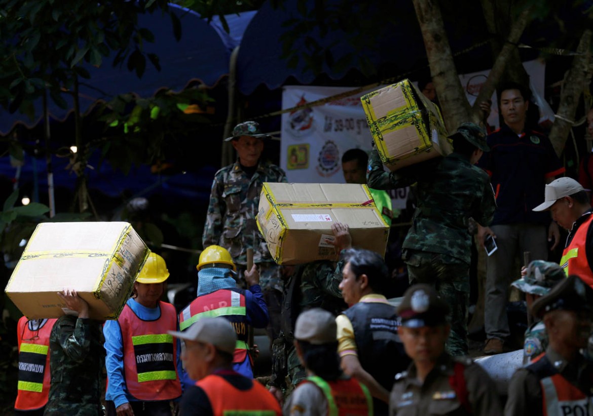 Soldiers and rescue workers carry aid supplies to the Tham Luang cave complex, as members of an under-16 soccer team and their coach have been reported by local media to be found alive, in the norther