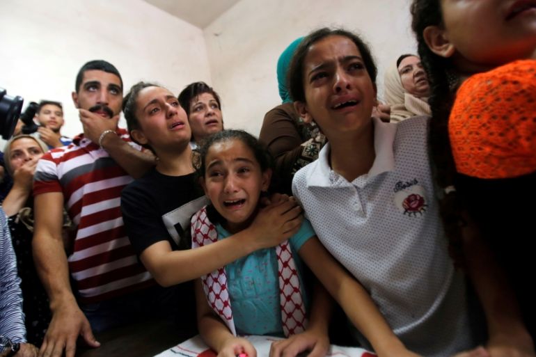 Relatives of Palestinian teenager Arkan Mezeher, who was killed by Israeli soldiers during a raid, mourn during his funeral in Dheishe refugee camp, near Bethlehem, in the occupied West Bank