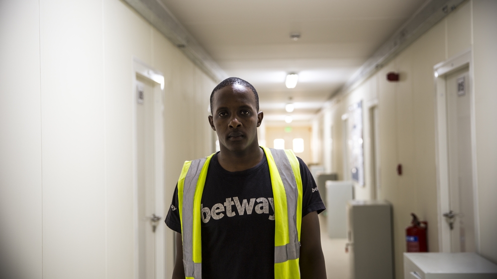 After arriving in Qatar, Daniel Gathuru was told he didn't have to pay to get this job [Faras Ghani/Al Jazeera]