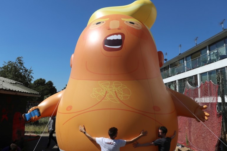 People inflate a helium filled Donald Trump blimp which they hope to deploy during The President of the United States'' upcoming visit, in London