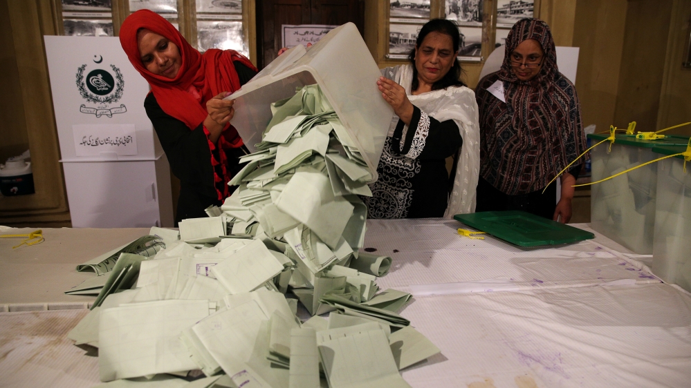 Election officials count ballots in Islamabad after polls closed during the general elections [Athit Perawongmetha/Reuters]