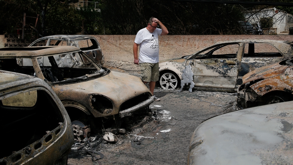 The wildfire in Mati destroyed cars and engulfed houses [Costas Baltas/Reuters]