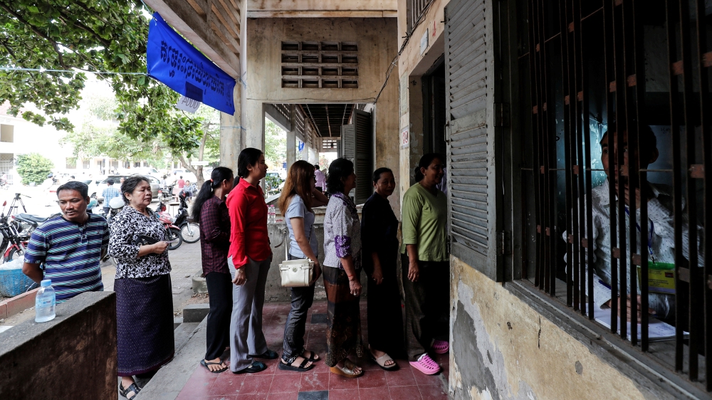 People line up to vote at a polling station during a general election in Phnom Penh [Darren Whiteside/Reuters]