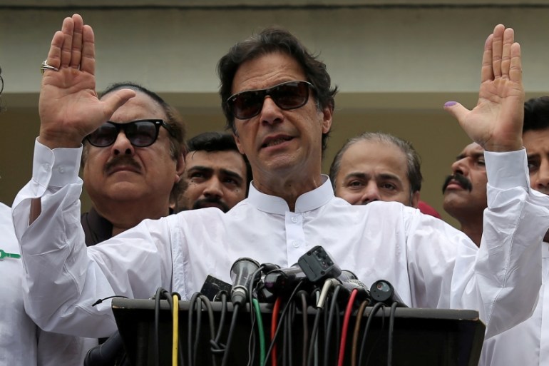 Imran Khan speaks to members of media after casting his vote at a polling station during the general election in Islamabad