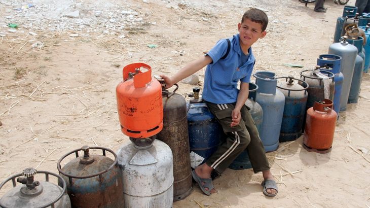 A Palestinian boy waits to fill cooking gas canisters at a gas station in Gaza May 13, 2008. Israel resumed fuel shipments to Gaza''s main power station on Monday, a senior generating plant official s