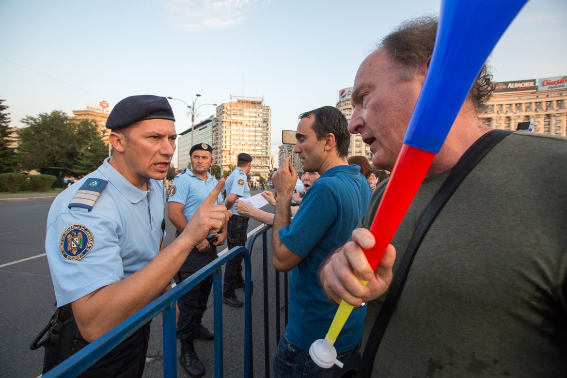6. A protester is confronted by a gendarme during an anti corruption rally in Bucharest.
