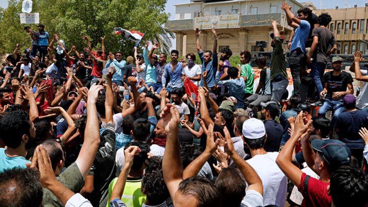 Iraqi protesters gather in front of the provincial council building during a demonstration