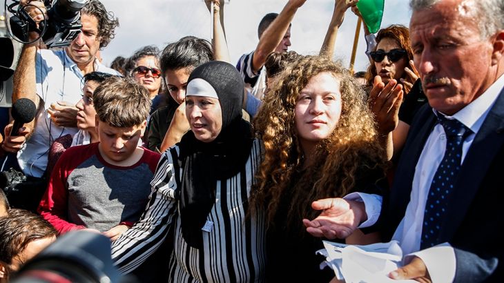 Palestinian activist and campaigner Ahed Tamimi (C) stands alongside her father (R), mother (C-L), and brother (L) upon her release from prison after an eight-month sentence for slapping two Israeli s