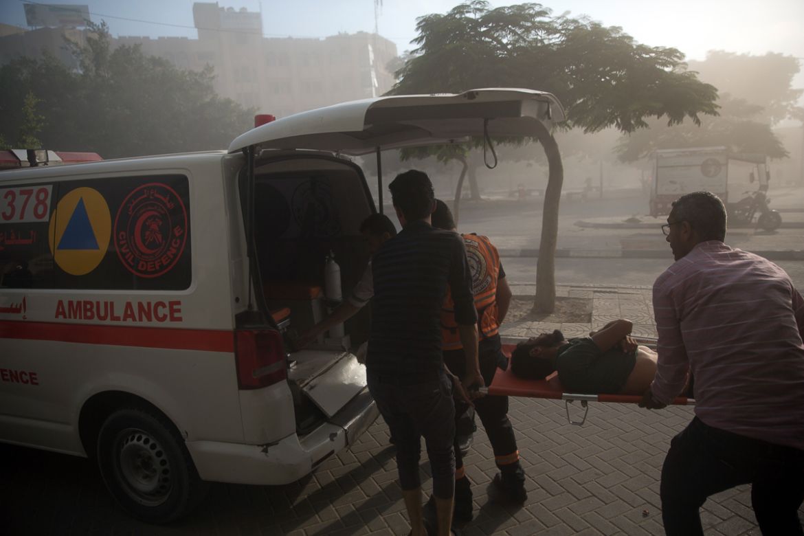 Medics evacuate a wounded Palestinian man following an Israeli airstrike hits a governmental building in Gaza City , Saturday, July 14, 2018.The Israeli military carried out its largest daytime airstr