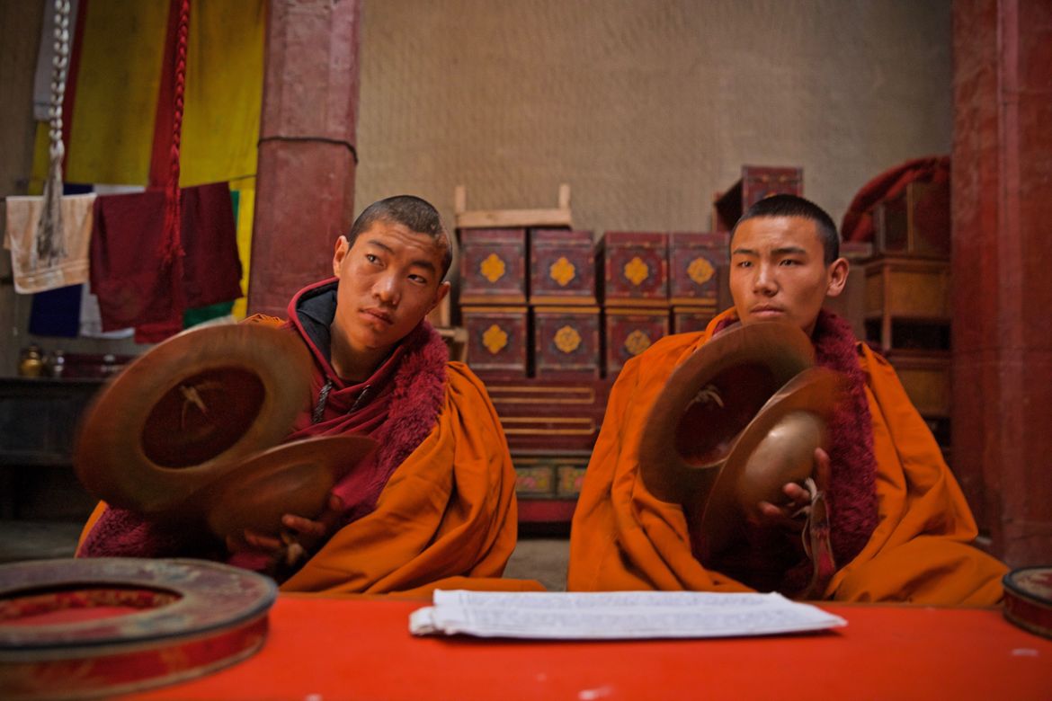 Young monks try to follow along during a worship practice in Lo Manthang, Mustang. As more idols are stolen from religious sites, many fear that Buddhism and a traditional way of life in these remote