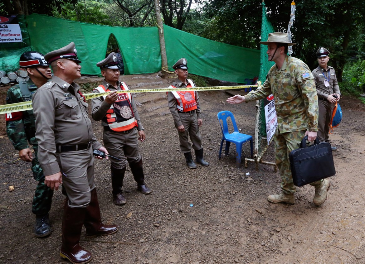 Australian Federal Police and Defense Force personnel arrive near a cave where 12 boys and their soccer coach have been trapped since June 23, in Mae Sai, Chiang Rai province, in northern Thailand Sun