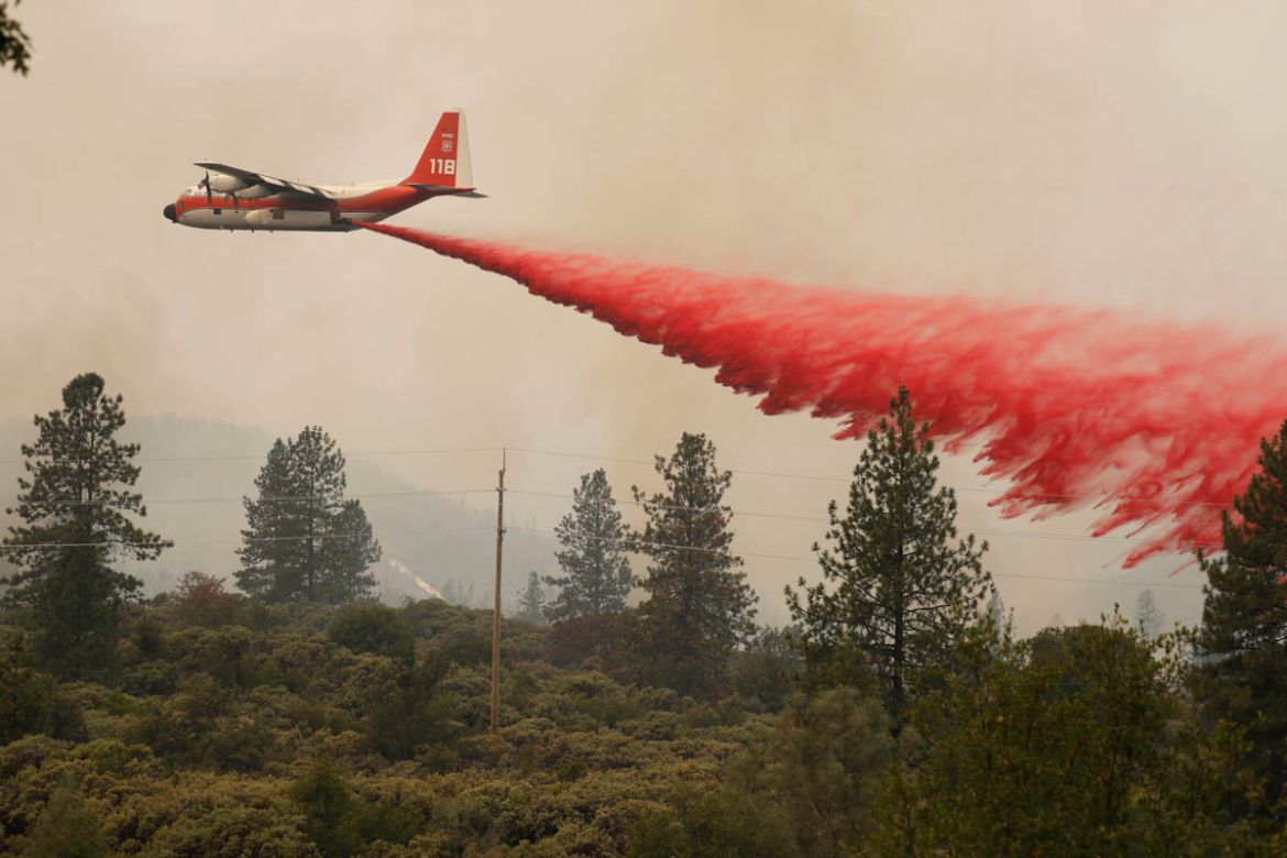 An aircraft drops fire retardant to slow the spread of the Carr Fire, west of Redding, California, U.S. July 27, 2018. REUTERS/Fred Greaves