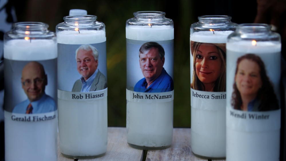 Candles representing the slain journalists of Capital Gazette sit on display during a candlelight vigil [Leah Millis/Reuters]