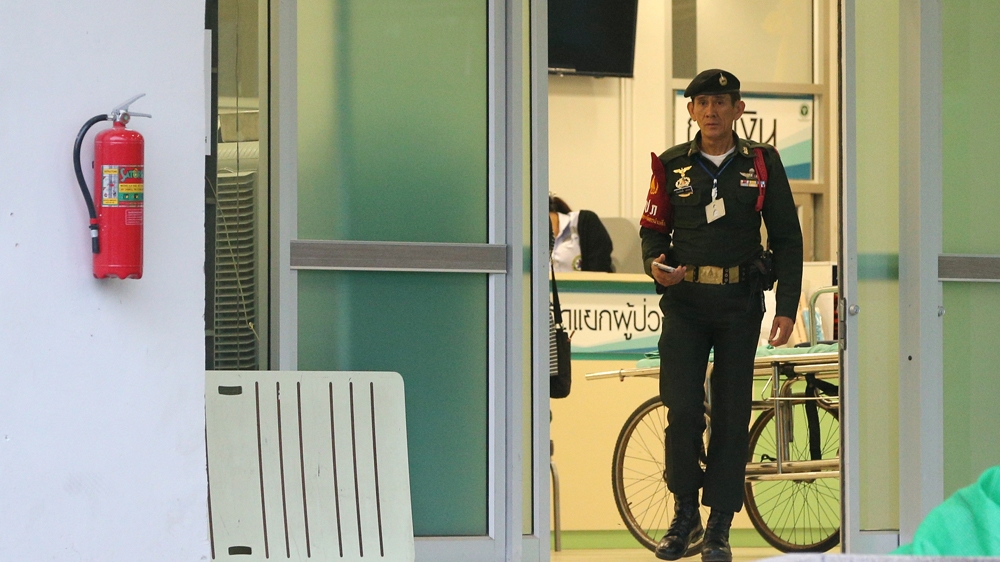 A security officer walks out of the Chiang Rai Prachanukroh hospital where those who were rescued from the flooded cave are being treated [Athit Perawongmetha/Reuters]
