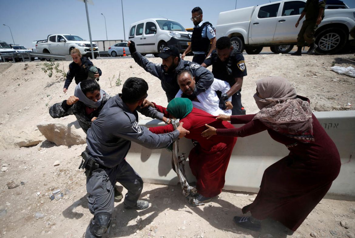 Israeli policemen try to detain Palestinians in the Bedouin village of al-Khan al-Ahmar near Jericho in the occupied West Bank July 4, 2018. REUTERS/Mohamad Torokman TPX IMAGES OF THE DAY