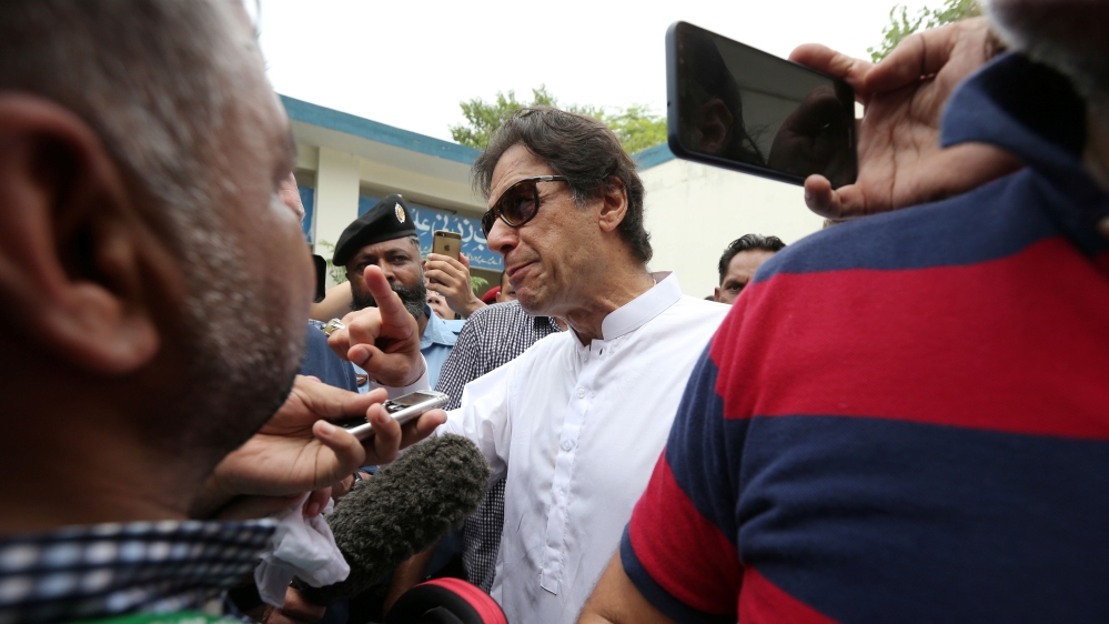 Imran Khan arrives at a polling station during the general election in Islamabad [Athit Perawongmetha/Reuters]