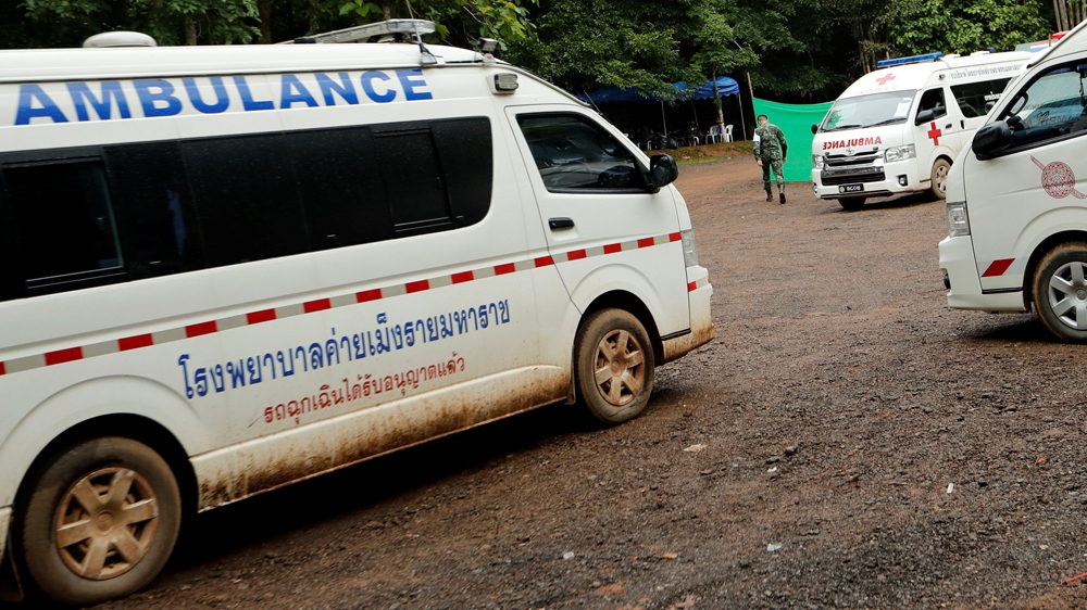 Ambulances are seen outside the Tham Luang cave complex after media have been ordered out [Tyrone Siu/Reuters]