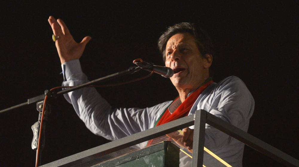 Pakistani cricketer-turned-politician Imran Khan of the Pakistan Tehreek-e-Insaf (Movement for Justice), speaks to supporters in Karachi [Rizwan Tabassum/AFP]