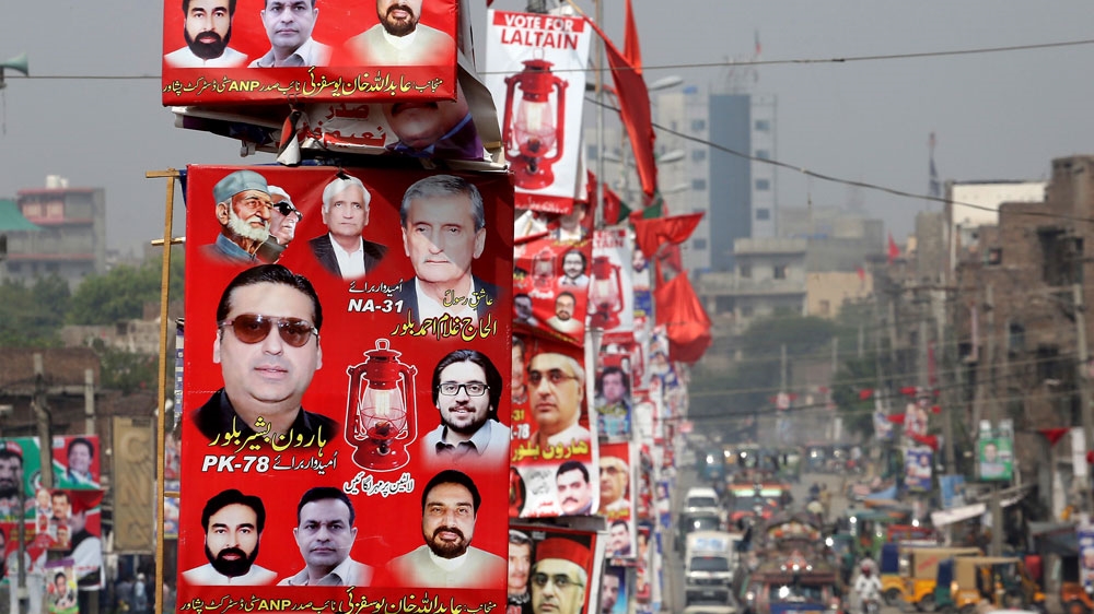 Election banners for ANP line a road in Peshawar, Pakistan [Muhammad Sajjad/AP]