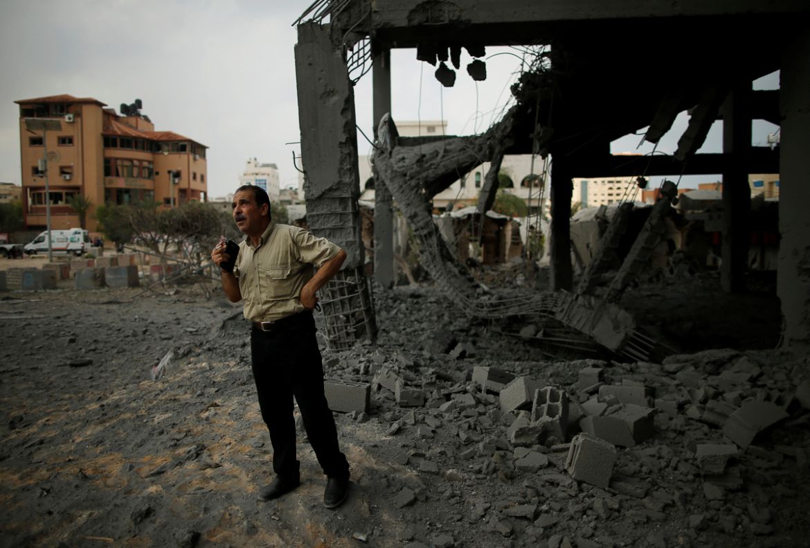 A Palestinian man looks at a building that was destroyed by Israeli air strikes in Gaza City, July 15, 2018. REUTERS/Suhaib Salem