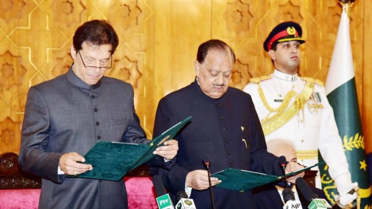 Cricketer-turned-politician Imran Khan takes the oath of the Prime Minister from President Mamnoon Hussain at the Presid House in Islamabad