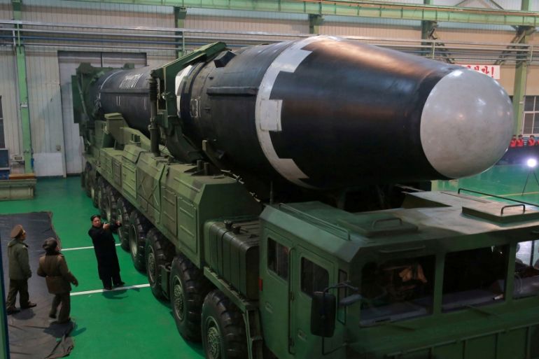 North Korea Hwasong-15 misslle on a transporter with Kim Jong Un looking at it