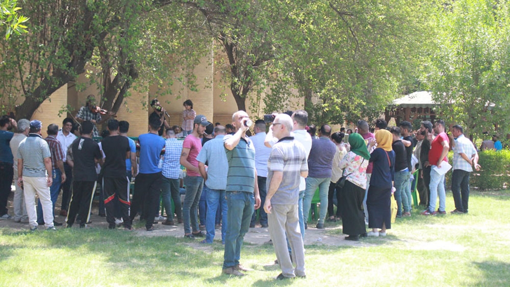 Visitors to al-Qishla's gather for a music performance in the middle of the gardens surrounding the ancient Ottoman barracks [Arwa Ibrahim/Al Jazeera]
