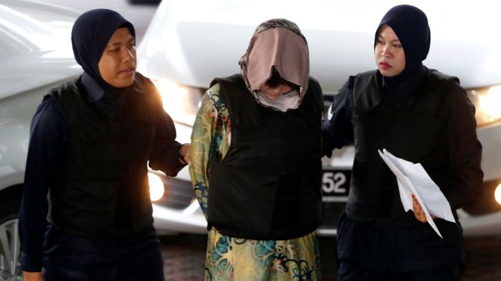 Vietnamese Doan Thi Huong is escorted as she arrives at the Shah Alam High Court